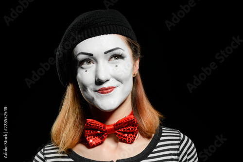 Beautiful female mime on black
