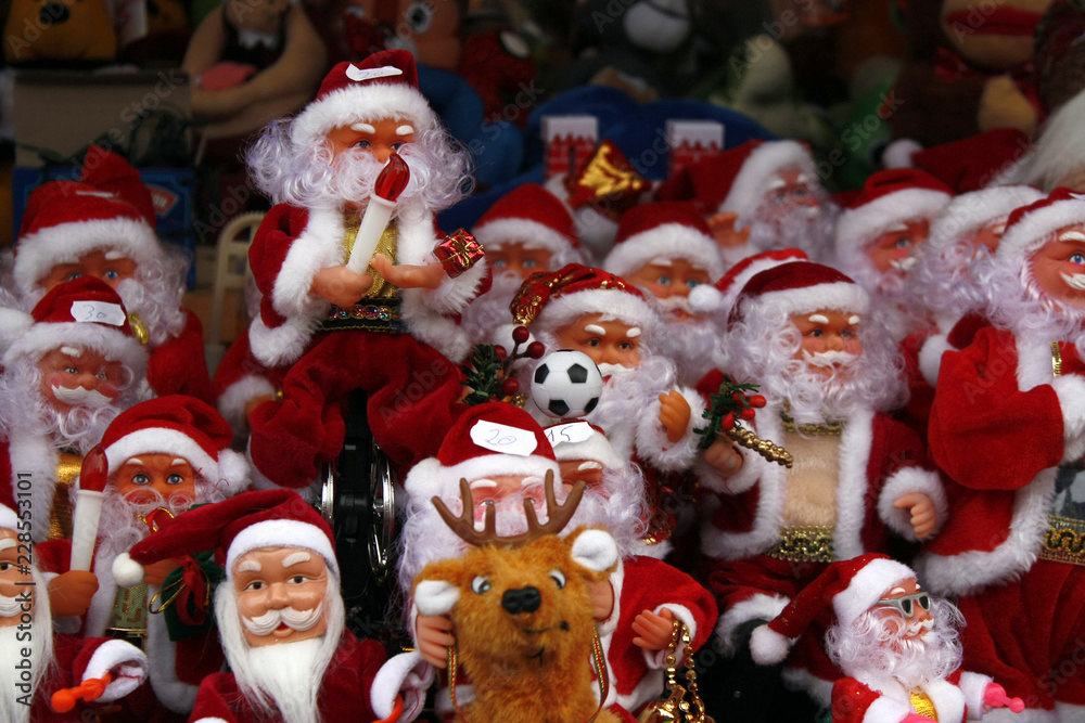 Group of toy Santa in red with candles and reindeer 