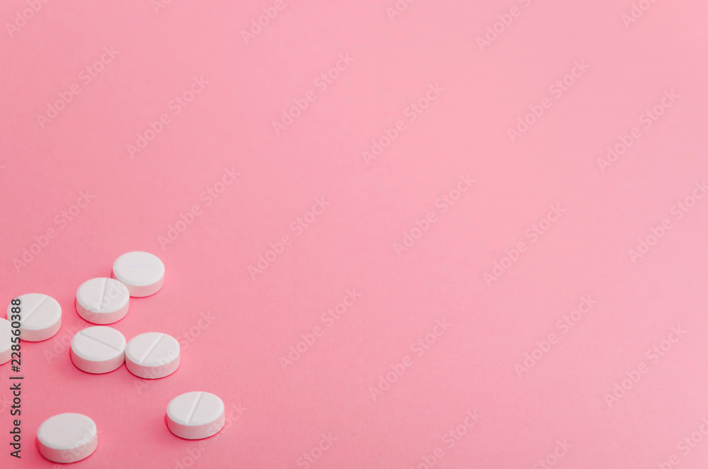 Close-up of pills in the left-down corner of the pink background Close-up of pills in the left-down corner of the pink background