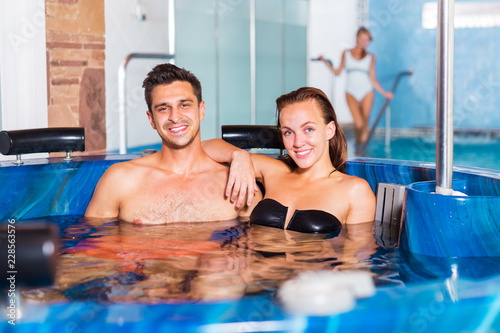Couple relaxing in spa pool © JackF