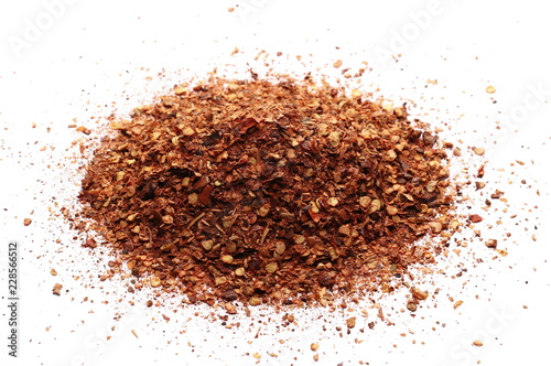 pile dry crushed red pepper, dried chili flakes and seeds isolated on white background