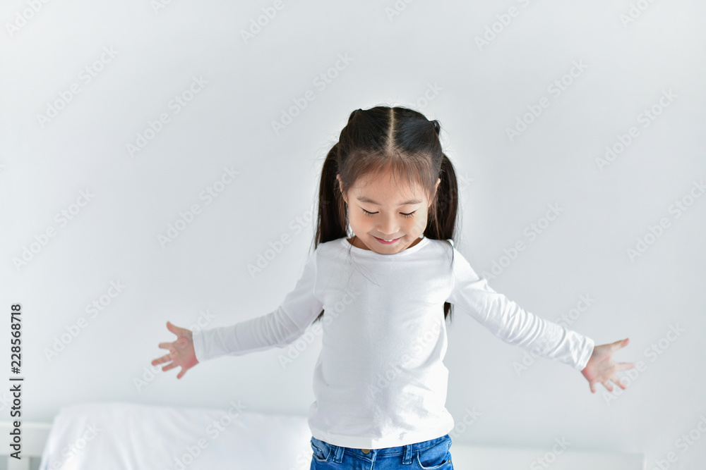 Emotional girls play in a white bedroom. Emotional girls play in a white bedroom.