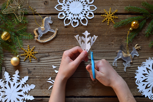 Making paper snowflakes with your own hands. Children's DIY. Merry Christmas and New Year concept. Step 2. Cut the snowflake