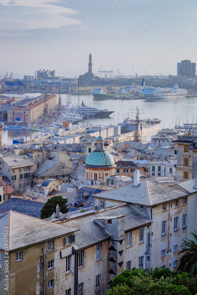 Historical center and the port of Genoa at dusk in Genoa, Italy