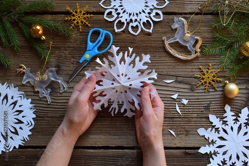 Making paper snowflakes with your own hands. Children's DIY. Merry Christmas and New Year concept. Step 3. Open the snowflake