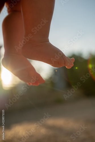 baby legs, feets 6 month baby, lens flaire photo