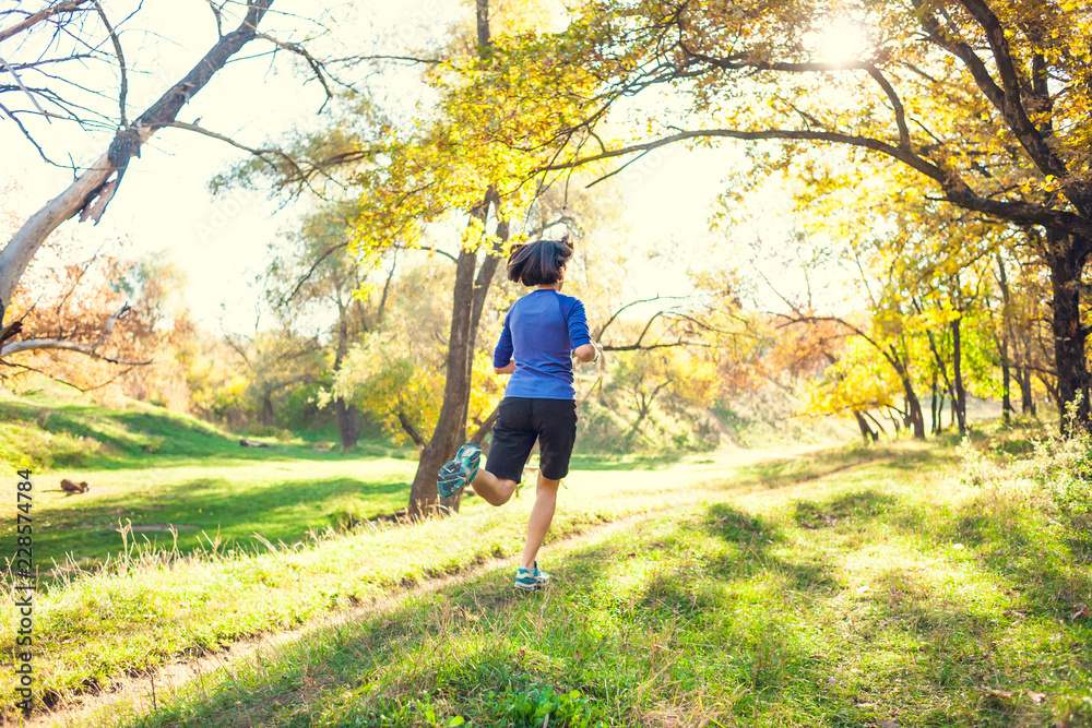 The girl runs through the autumn park. The girl runs through the autumn park.