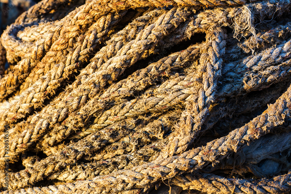 Old ship ropes tied to an anchor, parking system of marine ship. sign of force, help and chaning 