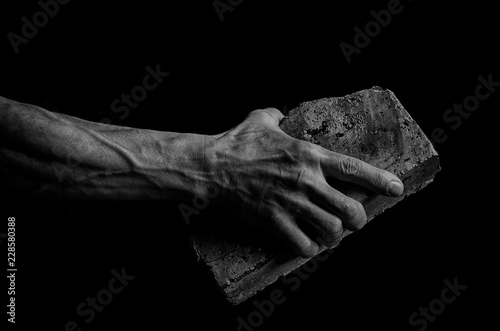Male hand holds brick