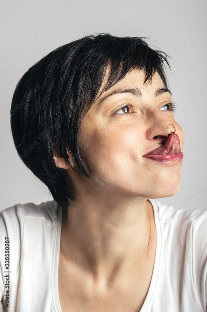 Young beautiful woman licking the chocolate of her nose Young beautiful woman licking the chocolate of her nose