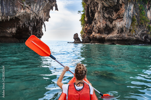Canvas Print Woman paddles kayak in the tropical sea