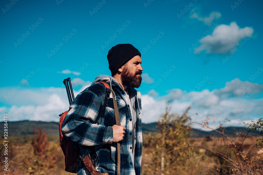 Hunter with shotgun gun on hunt. Man holding shotgun. Clothes for the