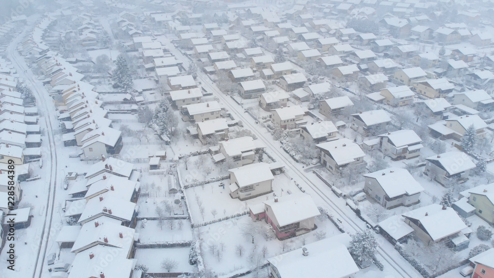 AERIAL: Pristine white snow covers the empty streets of a suburban neighborhood. AERIAL: Pristine white snow covers the empty streets of a suburban neighborhood.