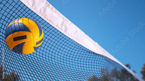 Tableau sur toile COPY SPACE: Ball gets caught in a black and white net during volleyball game