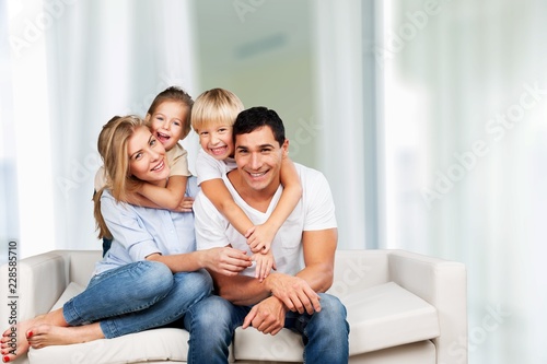 Young family at home smiling at camera