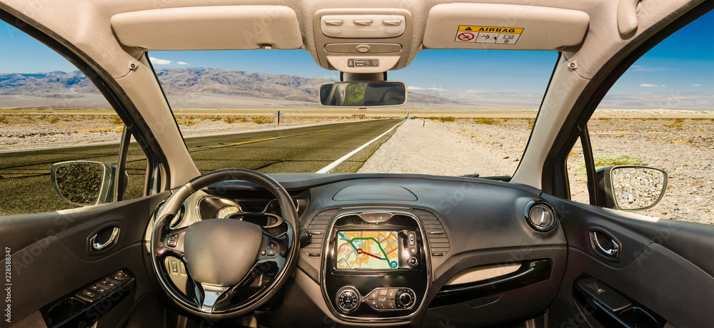 Car windshield with view of desert road, Death Valley, USA