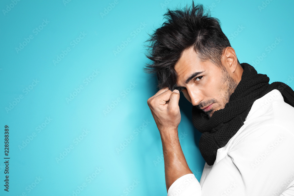 Young man with trendy hairstyle posing on color background Young man with trendy hairstyle posing on color background