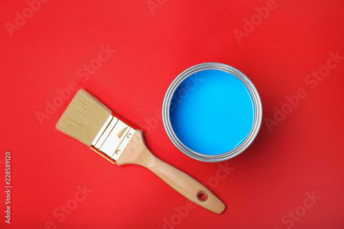 Fototapeta Naklejka Na Ścianę i Meble -  Flat lay composition with paint can and brush on red background