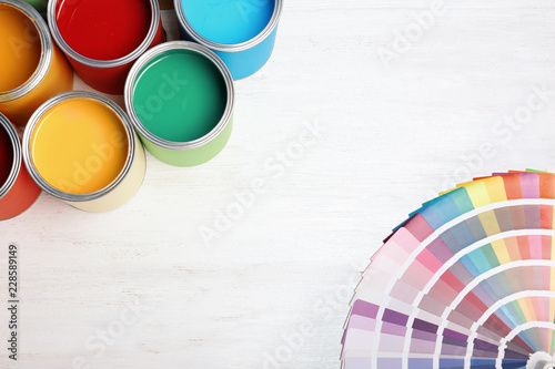 Fototapeta Naklejka Na Ścianę i Meble -  Flat lay composition with paint cans and color palette on wooden background. Space for text