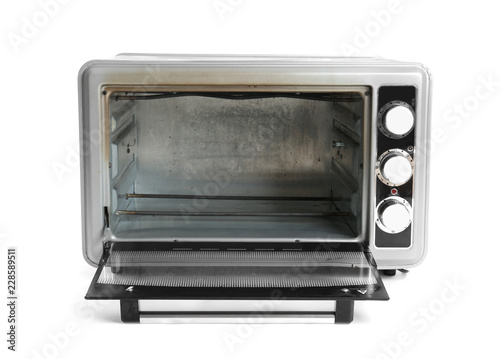 Open dirty modern electric oven on white background