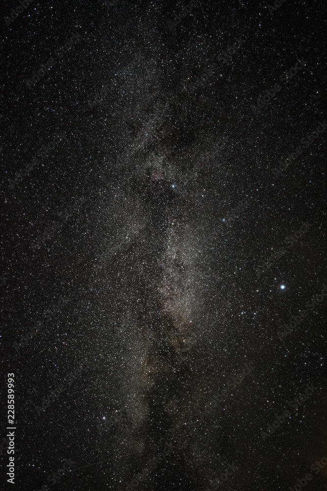 Bright milky way on a summer night through the clouds