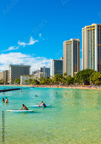 HONOLULU, HAWAII - FEBRUARY 16, 2018: Surfer at Waikiki beach. Copy space for text. Vertical.