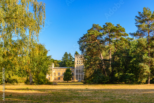 Scenery of the house, Kavaliershaus, surrounded by tree at Pfaueninsel, Peacock island, located on Wannsee lake in Berlin, Germany in Autumn season and sunset light. © Peeradontax