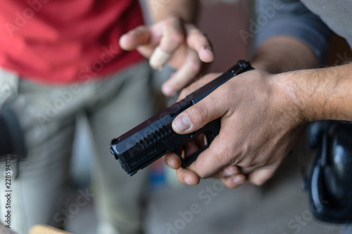 Close Up on Hand Holding a Gun