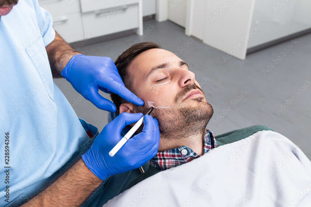 peaceful-male-patient-with-correction-lines-on-the-face-in-an