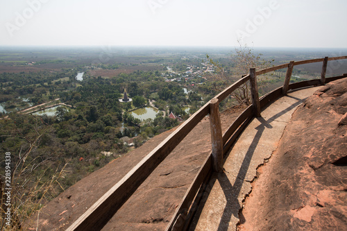 wooden bridge and old wooden banister, walkway around stone mountain. dangerous walkway made by wooden in Thailand