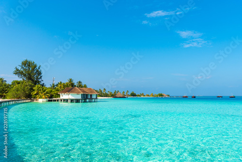 Water villa in a row by the seashore, Maldives. Copy space for text.
