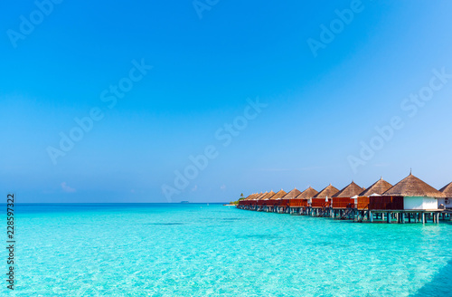 Water villas in a row by the seashore, Maldives. Copy space for text.