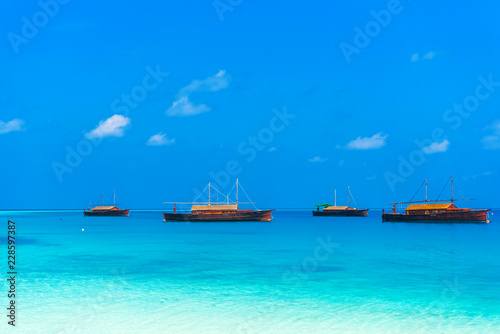 Dhoni boats in turquoise water, Maldives. Copy space for text.