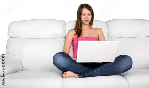Portrait of a Young Woman Using her Laptop While Sitting on a