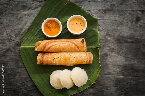 South Indian Vegetarian meal paper Masala Dosa chutney and sambar on Banana leaf photo