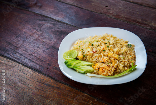 Crab meat fried rice, Khao Pad Poo. Thai famous street food. Thai recommend menu for tourist. fried rice with crab meat and egg, cucumber on side dish.