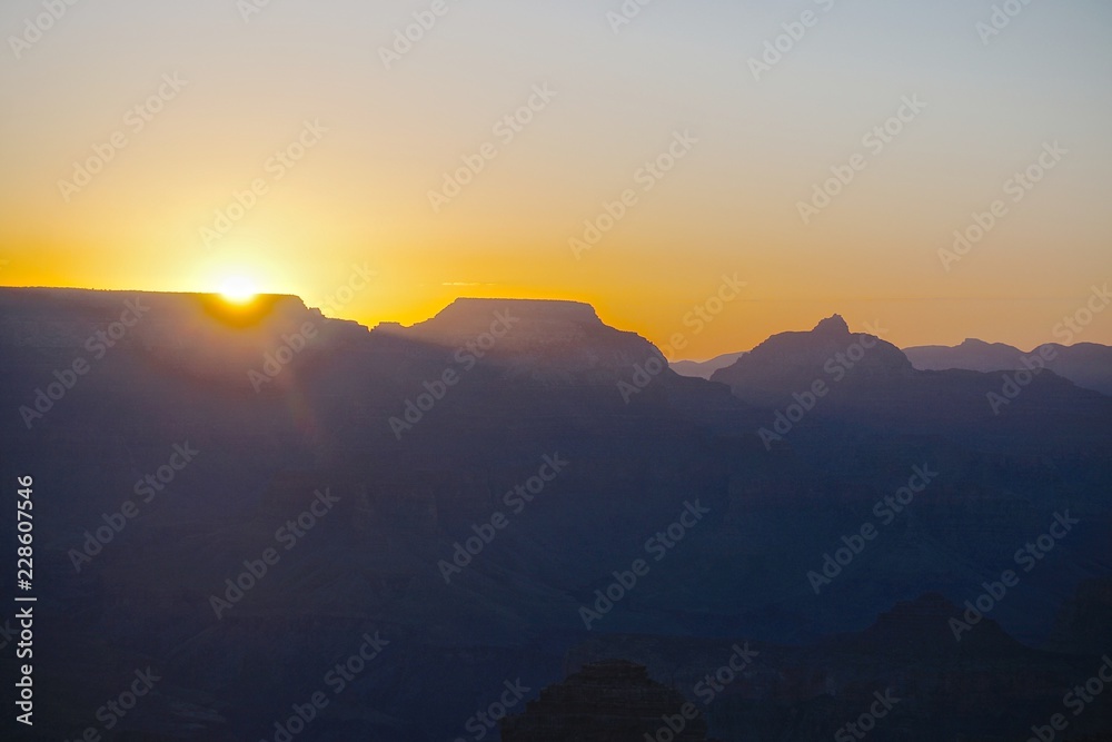 Grand Canyon National Park, Arizona, USA: Sunrise viewed from the South Rim of the Grand Canyon, with muted shades of blue and gold.