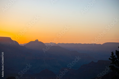 Grand Canyon National Park, Arizona, USA: Sunrise viewed from the South Rim of the Grand Canyon, with muted shades of blue and gold.