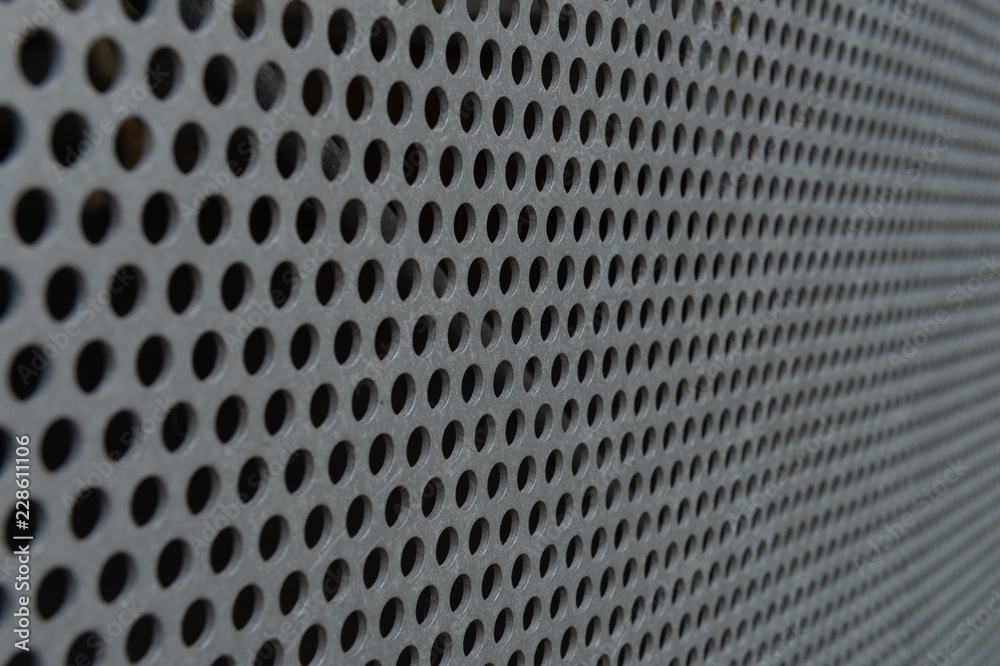 White metal plate with many small circular holes