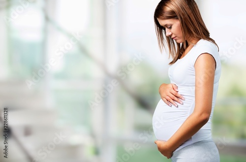 Free Download Pregnant young woman in white t shirt on  background - GFXLoad