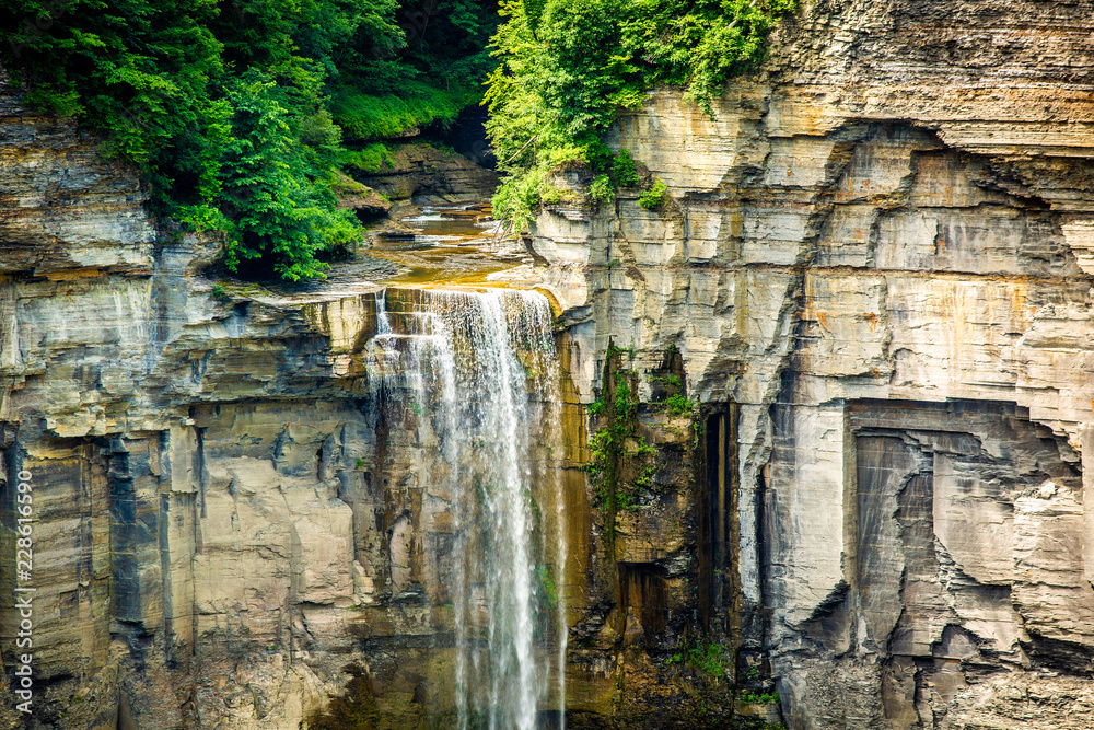 Scenic high mountain waterfall at sunny day