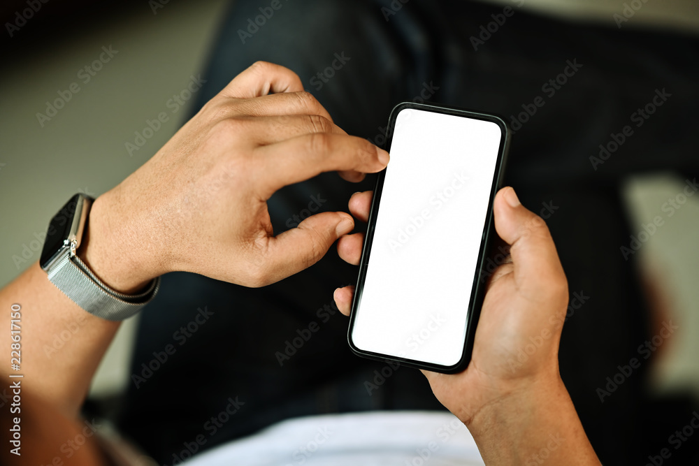 Man holding smart phone with blurred background. For Graphic display montage. Man holding smart phone with blurred background. For Graphic display montage.