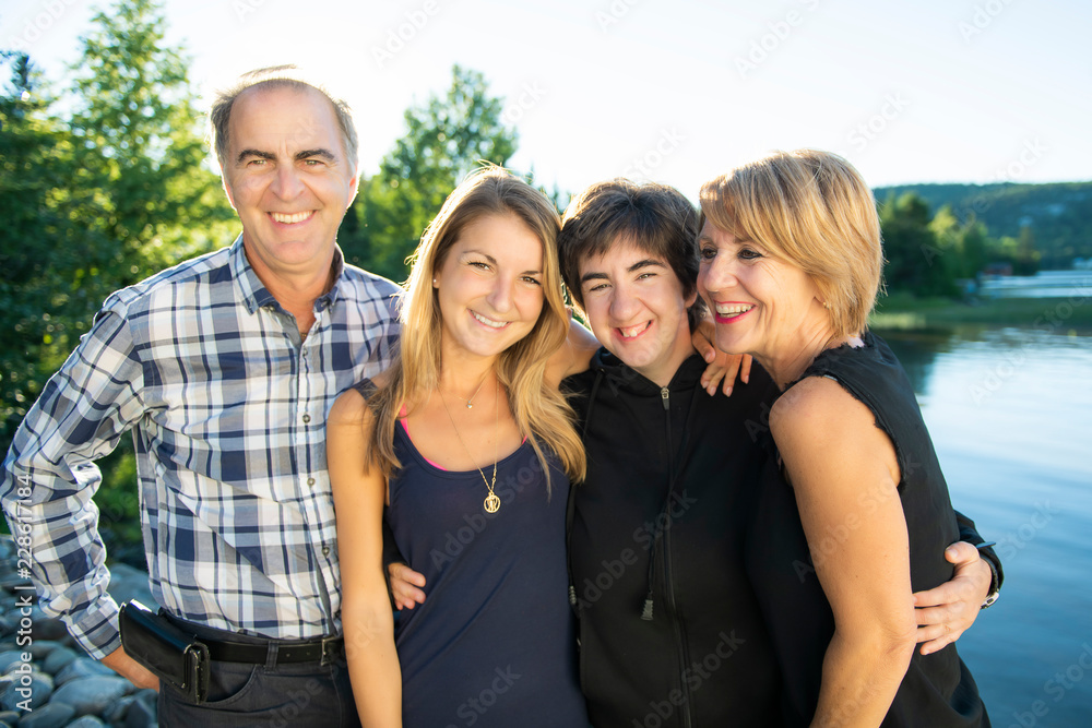 Couple outdoors with childs by lake having good time