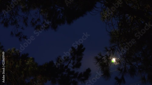 Helicopter flying in night operations with searchlight.