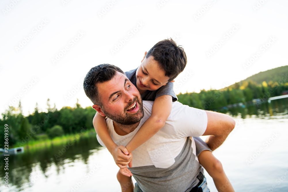 father and son on the pier warm summer day having good time father and son on the pier warm summer day having good time