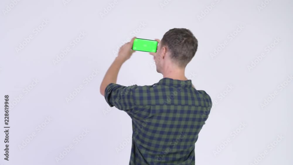 Rear view of hipster man taking picture with phone Rear view of hipster man taking picture with phone