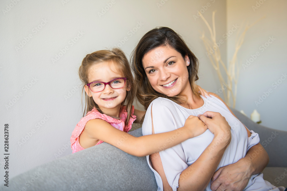 mother and daughter Having great time on the sofa mother and daughter Having great time on the sofa