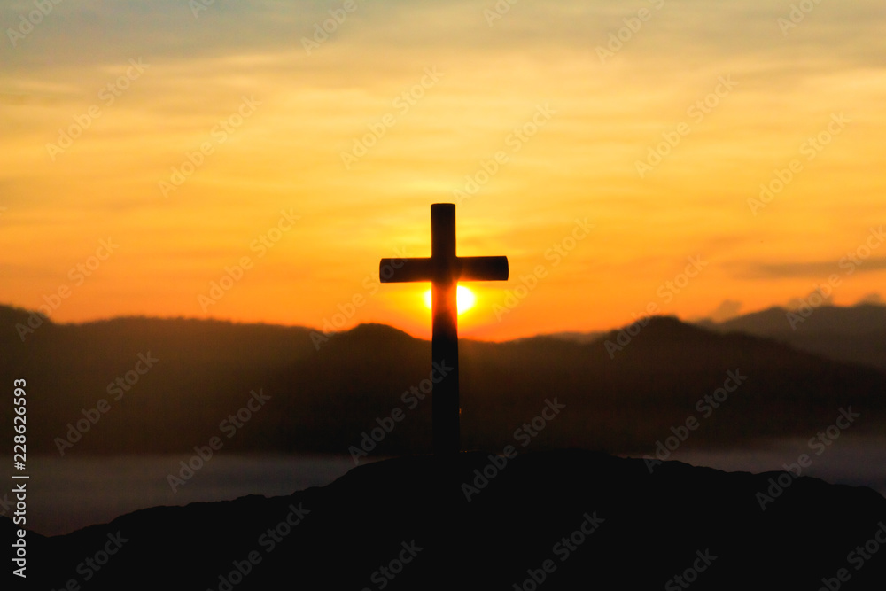 silhouette cross on mountain at mountain sunrise