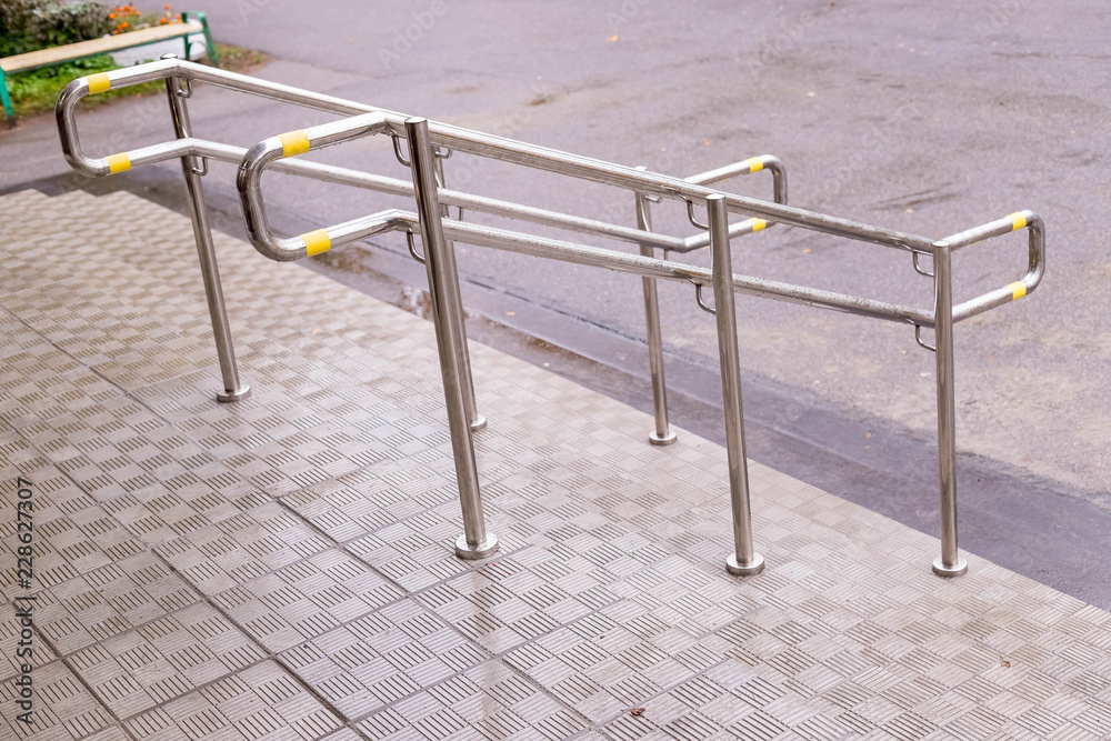 Stainless steel handrails are installed on the walls and steps.steel handrail.assistance for people with limited mobility, for the elderly.Copy space.stairway enclosure with metallic stair railing Stainless steel handrails are installed on the walls and steps.steel handrail.assistance for people with limited mobility, for the elderly.Copy space.stairway enclosure with metallic stair railing