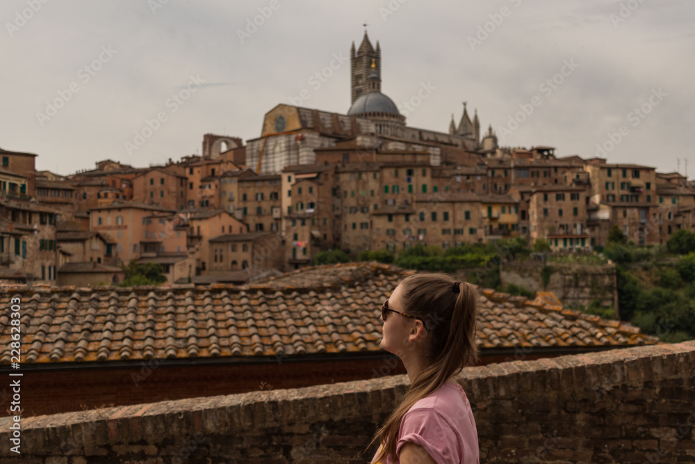 young woman in front of sienna